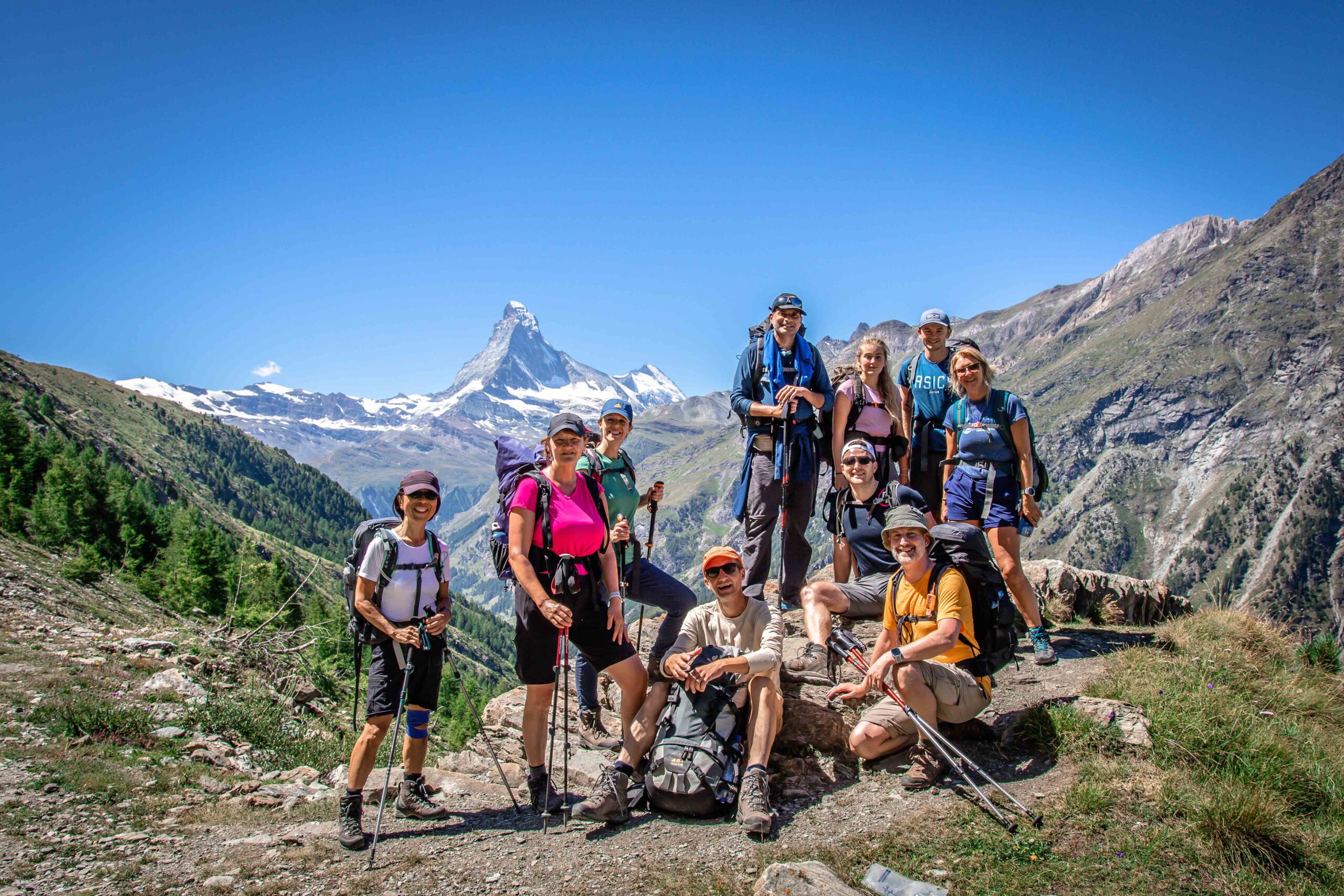 A group of hikes in the Alps on Chamonix to Zermatt Haute Route trek with snow capped Matterhorn in the background