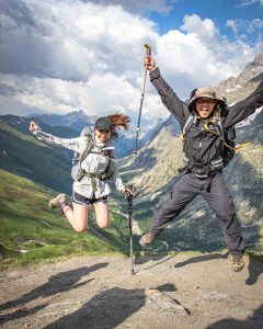 Happy Hikers jumping in Val Ferret, guided Tour du Mont Blanc