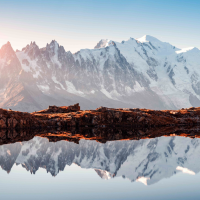 Autumn still Lac Blanc reflection of Mont Blanc View of the Mont Blanc summits in snow reflected also on the Lac Blanc surface in fold morning light on Tour du Mont Blanc trekking trail