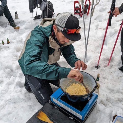 Joel wearing his Salomon MTN to cook up a fondue!