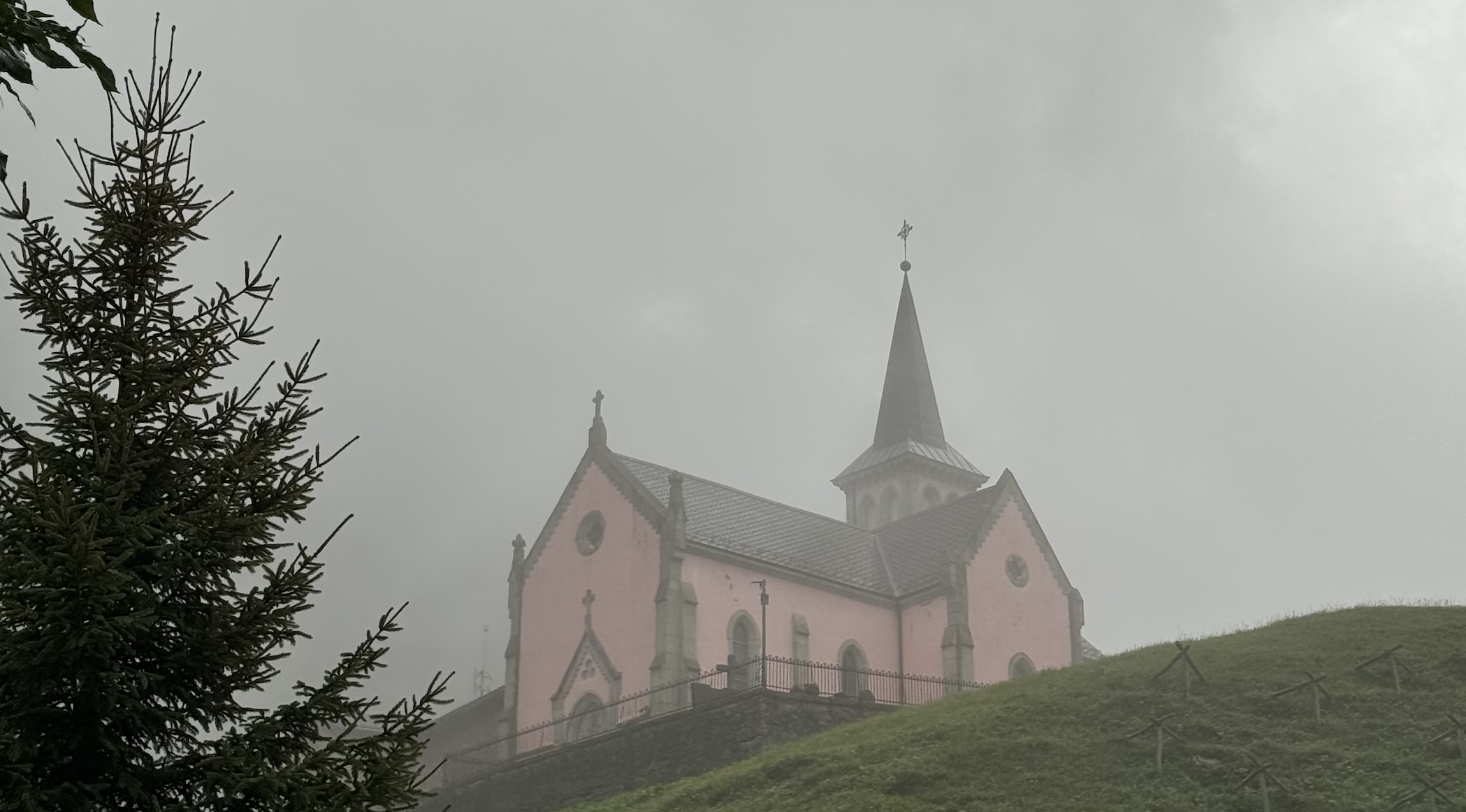 pink church of Trient in the clouds