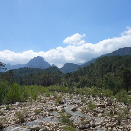 View of the Corsican mountain ranges from a dry river bed
