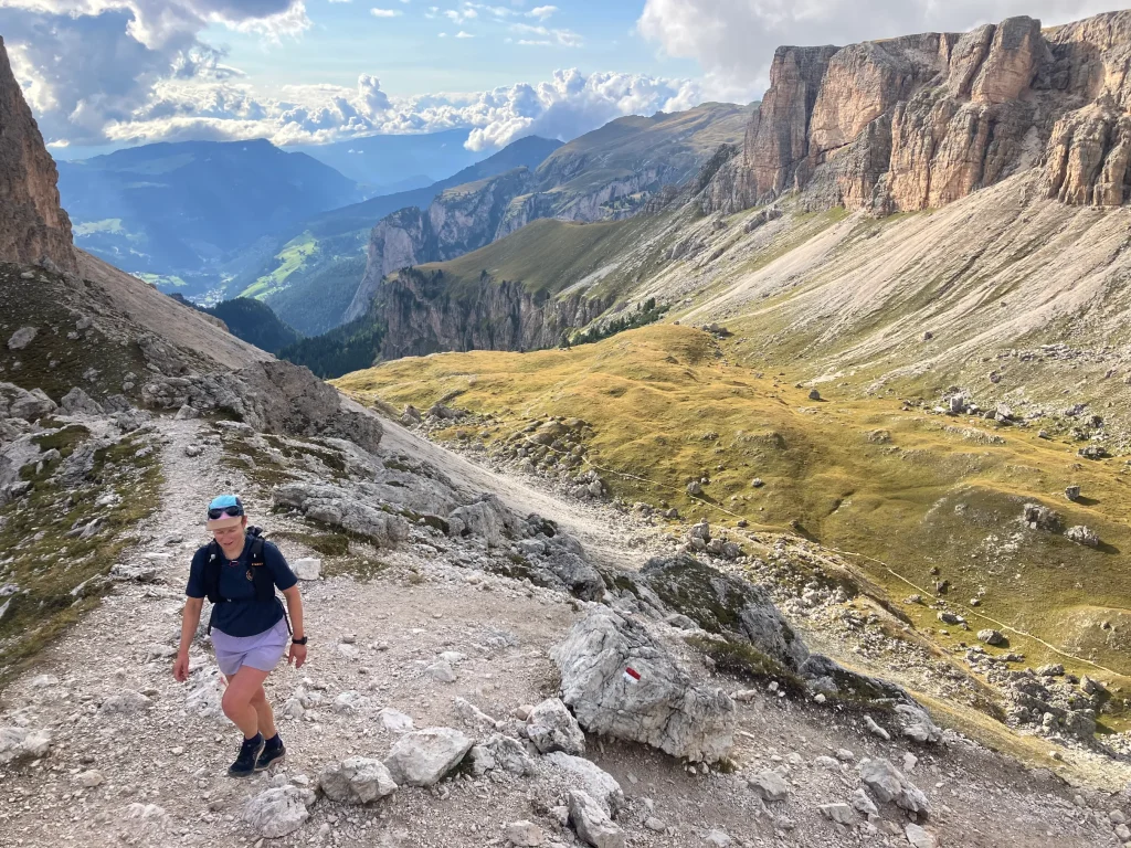 A hiker climbing up toward Rifugio Puez on AV2 trek in the Dolomites