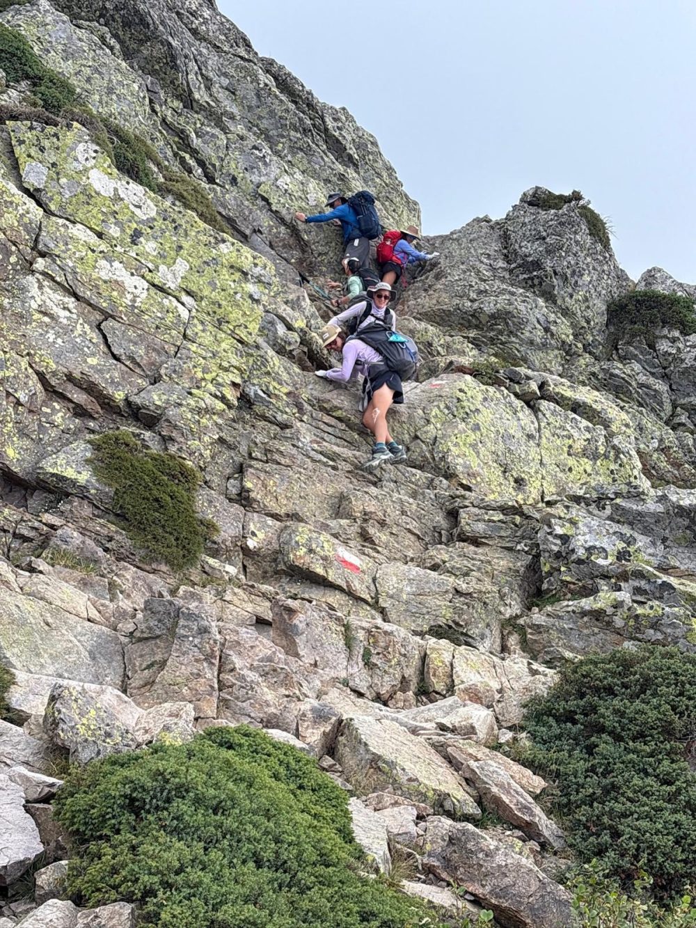Scramble GR20 Hikers on a rocky section of the GR20 hike in Corsixa