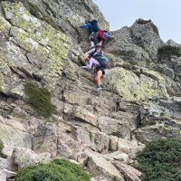 Scramble GR20 Hikers on a rocky section of the GR20 hike in Corsixa